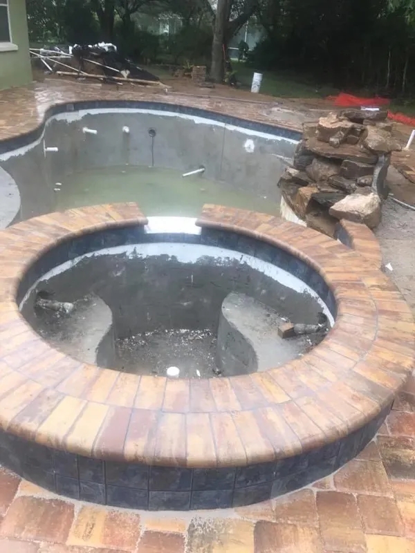 Luxurious paver hot tub pad crafted by BMW Services.
